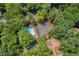 Aerial view of the community amenities including a pool, tennis courts, and playground surrounded by lush trees at 3086 Colony Rd # C, Durham, NC 27705