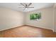 Bedroom with a ceiling fan, hardwood floors, and a window overlooking the trees at 3086 Colony Rd # C, Durham, NC 27705