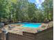 A refreshing community pool featuring plenty of lounge chairs and surrounding trees, perfect for relaxation at 3086 Colony Rd # C, Durham, NC 27705