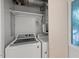 Functional laundry room features a washer, dryer, and storage shelving at 3086 Colony Rd # C, Durham, NC 27705