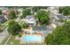 Aerial view showcasing an in-ground pool, a patio, and a lush yard in a tree-lined neighborhood at 309 W Divine St, Dunn, NC 28334