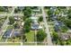 Aerial view of the neighborhood showing mature trees and houses with a community pool at 309 W Divine St, Dunn, NC 28334