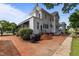 Backyard brick patio with a grill, stairs to an upper level and mature landscaping at 309 W Divine St, Dunn, NC 28334