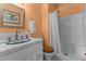 Bathroom features a walk-in shower and sink with white tile, plus light orange painted walls at 309 W Divine St, Dunn, NC 28334