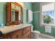 Charming bathroom featuring vanity, mirror, and a walk-in shower at 309 W Divine St, Dunn, NC 28334
