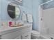Bathroom features a walk-in shower and sink with white tile, plus light blue painted walls at 309 W Divine St, Dunn, NC 28334