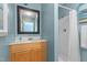 Cozy bathroom featuring a light wood vanity and shower with a white shower curtain at 309 W Divine St, Dunn, NC 28334