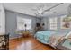 Comfortable bedroom features a canopy bed, hardwood floors, and abundant natural light at 309 W Divine St, Dunn, NC 28334