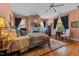 Bright bedroom featuring a fireplace, decorative rug, and a comfortable bed with colorful pillows at 309 W Divine St, Dunn, NC 28334