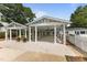 An elegant exterior featuring an elaborate white pergola structure with ample parking space at 309 W Divine St, Dunn, NC 28334