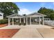 An elegant exterior featuring an elaborate white pergola structure with ample parking space at 309 W Divine St, Dunn, NC 28334