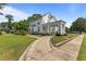 Charming home with a curved walkway, landscaped lawn and welcoming, columned front porch at 309 W Divine St, Dunn, NC 28334