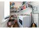 Well-equipped laundry room with ample storage shelving and a modern washer and dryer at 309 W Divine St, Dunn, NC 28334
