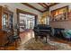 Comfortable living room featuring wood trim, a fireplace, and a grand piano at 309 W Divine St, Dunn, NC 28334