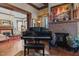 Comfortable living room with wood trim, a fireplace, and a grand piano at 309 W Divine St, Dunn, NC 28334