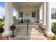 Charming front porch with classic columns and stone steps and comfortable seating at 309 W Divine St, Dunn, NC 28334