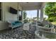 Covered porch with comfortable wicker furniture, stylish decor and a view of the neighborhood at 309 W Divine St, Dunn, NC 28334