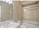 Bathroom with a tiled shower over tub, a large mirror, and neutral walls at 315 Allister Dr, Raleigh, NC 27609