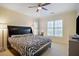 Relaxing bedroom with a ceiling fan, two windows with shutters, and neutral paint at 315 Allister Dr, Raleigh, NC 27609