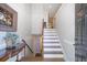 Inviting entryway featuring hardwood floors, staircase to the second level, and access to a finished basement at 315 Allister Dr, Raleigh, NC 27609