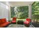 Screened-in patio with a seating area, lush greenery, and outdoor living at 315 Allister Dr, Raleigh, NC 27609