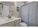 Cozy bathroom with a vanity, toilet, and shower with a patterned curtain at 317 Striped Maple Ct, Apex, NC 27539
