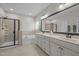 Well-lit bathroom with a tiled shower, soaking tub, and double sink vanity at 317 Striped Maple Ct, Apex, NC 27539
