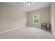 Bright, carpeted bedroom with neutral walls and a window offering ample natural light at 317 Striped Maple Ct, Apex, NC 27539