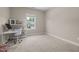 Bedroom featuring neutral colored walls, carpeted flooring, a desk, and shelving at 317 Striped Maple Ct, Apex, NC 27539