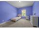 A bedroom painted with blue walls and carpeted flooring with a bed and two dressers at 317 Striped Maple Ct, Apex, NC 27539