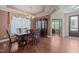 The dining room features decorative molding, hardwood floors, and large windows at 317 Striped Maple Ct, Apex, NC 27539