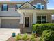 Front entrance with a covered porch, decorative columns, and lush landscaping at 317 Striped Maple Ct, Apex, NC 27539