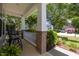 Inviting front porch with decorative columns and lush landscaping at 317 Striped Maple Ct, Apex, NC 27539