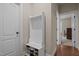 Hallway with a shoe rack and coat rack for convenience, and an open doorway to another room at 317 Striped Maple Ct, Apex, NC 27539