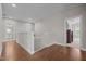 Upstairs hallway with hardwood floors, neutral paint, and access to bedrooms and bathrooms at 317 Striped Maple Ct, Apex, NC 27539
