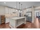 Modern kitchen featuring granite countertops, stainless steel appliances, hardwood floors and island with bar seating at 317 Striped Maple Ct, Apex, NC 27539