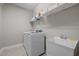 Functional laundry room with modern appliances and a utility sink for added convenience at 317 Striped Maple Ct, Apex, NC 27539