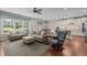 Comfortable living room with hardwood floors, neutral colors, a ceiling fan, and a view into the kitchen at 317 Striped Maple Ct, Apex, NC 27539