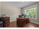 This office features a hardwood floor, neutral paint and a large window for natural light at 317 Striped Maple Ct, Apex, NC 27539