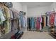 Organized walk-in closet with ample hanging space and shelving for storage at 317 Striped Maple Ct, Apex, NC 27539