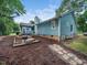 Home exterior showcases a spacious yard, deck, and fire pit area, perfect for outdoor living at 3400 Appling Way, Durham, NC 27703