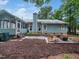 Relaxing backyard with outdoor fireplace, wood benches, screened in porch, and attractive landscaping at 3400 Appling Way, Durham, NC 27703