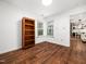 Neutral bedroom with hardwood floors, ample natural light, and a bookcase at 3400 Appling Way, Durham, NC 27703