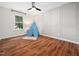 Bright bedroom with hardwood floors, neutral walls, and a whimsical blue and white play tent at 3400 Appling Way, Durham, NC 27703