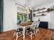 Charming dining room featuring modern lighting, wood floors and view to the backyard at 3400 Appling Way, Durham, NC 27703