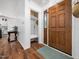 Inviting entryway with wood flooring, a wooden front door, and a convenient coat closet at 3400 Appling Way, Durham, NC 27703