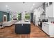 Stylish kitchen open to the living room, featuring stainless steel appliances and a large island at 3400 Appling Way, Durham, NC 27703