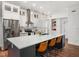 Open kitchen with a large center island with counter seating and stainless steel appliances at 3400 Appling Way, Durham, NC 27703