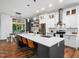 Modern kitchen with a large island, seating, stainless steel appliances, and pendant lighting at 3400 Appling Way, Durham, NC 27703