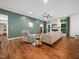 Comfortable living room with accent wall, fireplace, large windows, and plenty of natural light at 3400 Appling Way, Durham, NC 27703